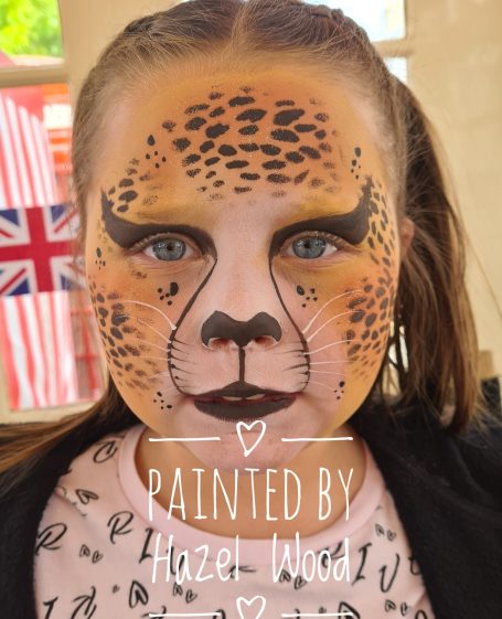 Leopard print face painted by Hazel