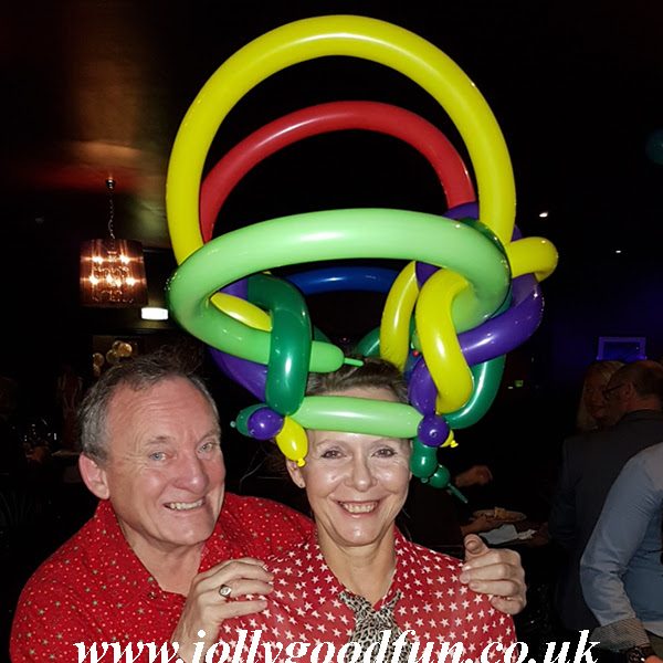 Lady wearing a fabulous balloon hat made by Ron