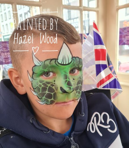 Dinosaur face painted by Hazel