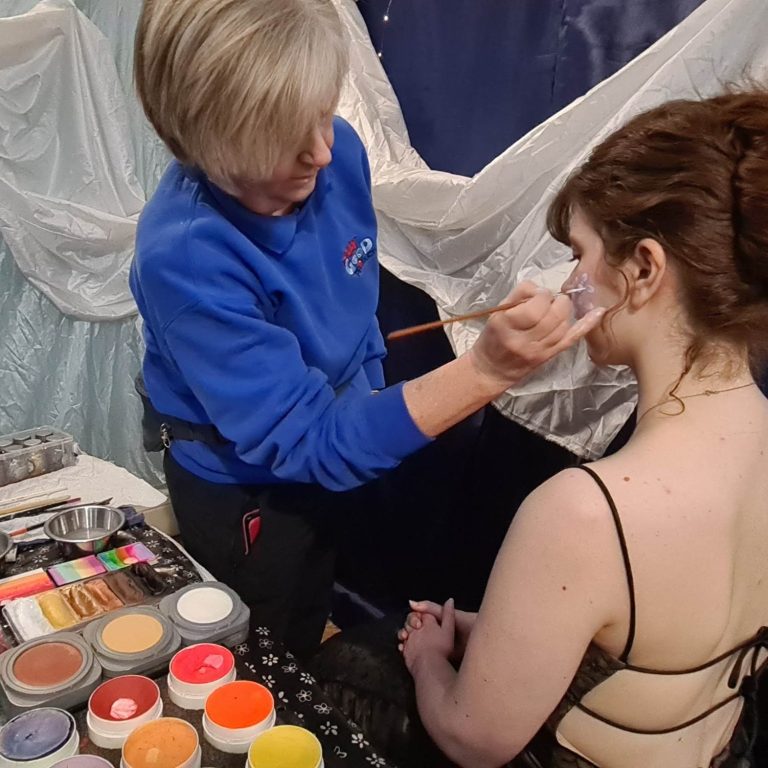 Hazel face painting at a student ball