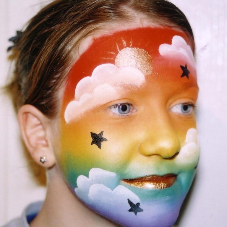 Rainbow face painted by Hazel