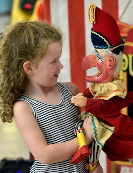 Child faces Mr Punch, nose to nose