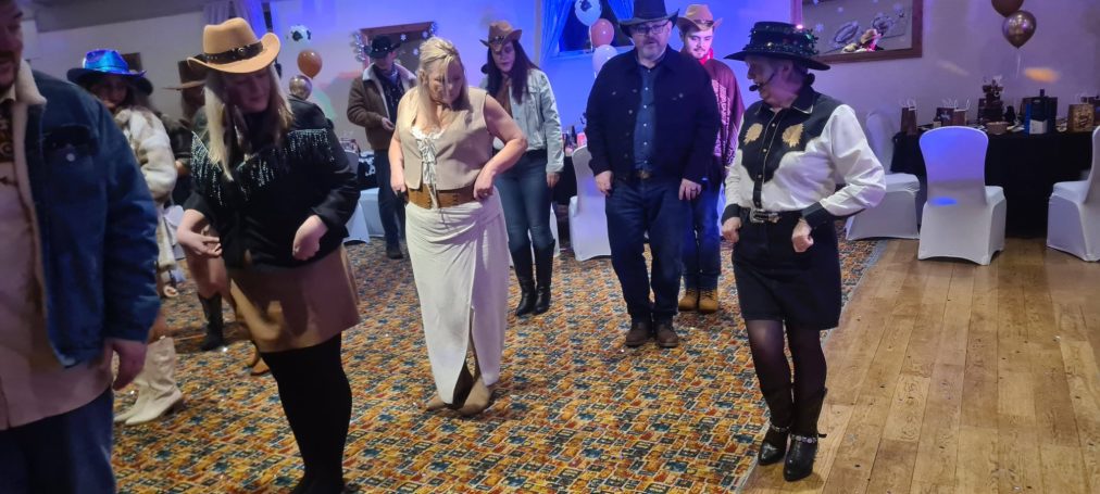 Hazel line dancing at a 6oth birthday bash